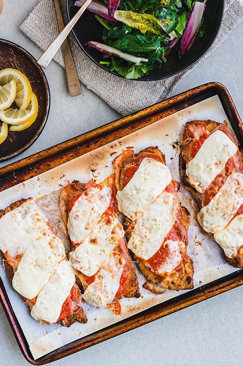 At a time when meat was scarce, they used to tenderize it to make it look as if there was more to eat. Each slice of veal (or you can use chicken) is coated with flour, egg, and breadcrumbs then fried to a crispy exterior and a tender interior. Served with tomato sauce, prosciutto slices, and cheese. 