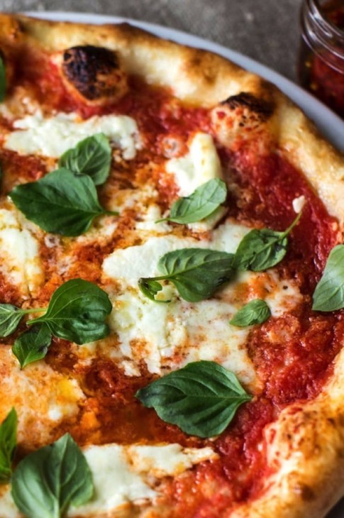 Pizza Margherita : la perfection est simple! La pizza, c’est mon mets préféré : celui que je peux manger 7 jours sur 7, 24 h sur 24 sans jamais m’en lasser. C’est un plat fantastique. Artistique même. La pâte est comme une toile vierge à laquelle on vient donner une couleur avec juste ce qu’il faut de garnitures.