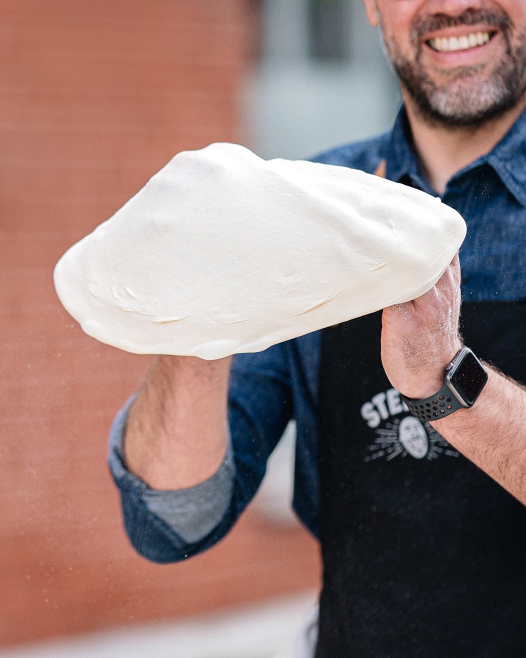 Stefano Faita tossing pizza dough